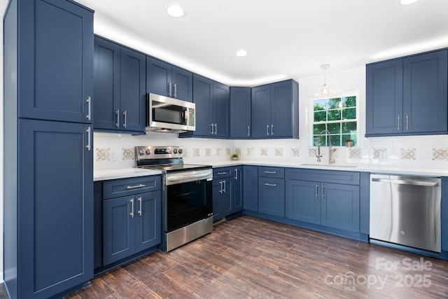 191 Harmony Grove Rd, Nebo, NC 28761 - kitchen featuring stainless steel appliances, blue cabinets, light countertops, dark wood-style floors, and recessed lighting