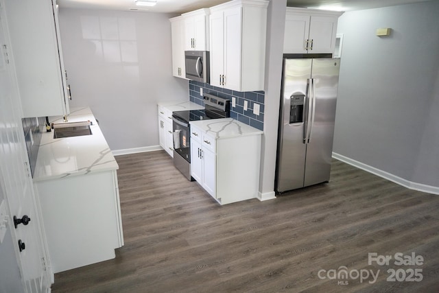 830 Mcarthur Ave, Charlotte, NC 28206 - kitchen featuring stainless steel appliances, dark wood-style flooring, decorative backsplash, white cabinets, and light stone counters