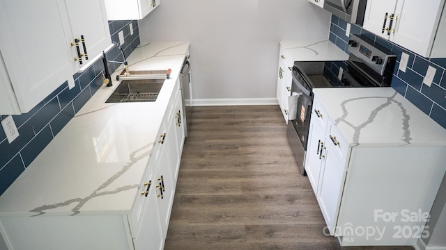 830 Mcarthur Ave, Charlotte, NC 28206 - kitchen with appliances with stainless steel finishes, tasteful backsplash, dark wood-style floors, and white cabinetry