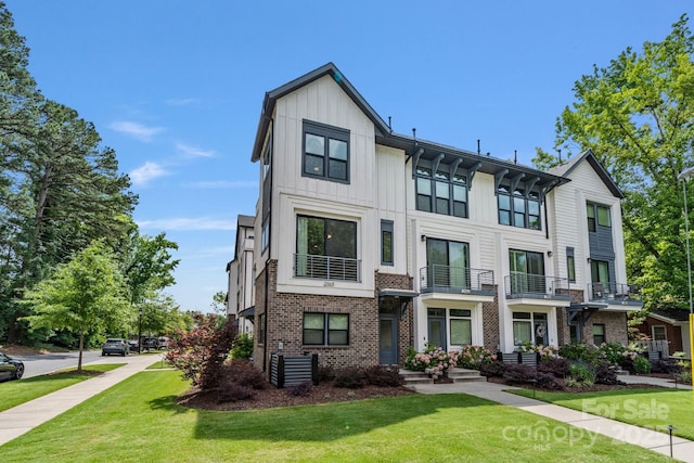 2969 Simpson Dr, Charlotte, NC 28205 - view of front of house with brick siding, a front yard, and board and batten siding