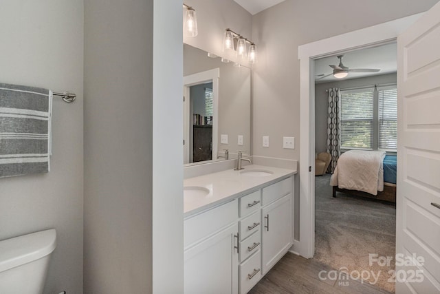 2969 Simpson Dr, Charlotte, NC 28205 - ensuite bathroom featuring double vanity, a ceiling fan, and wood finished floors