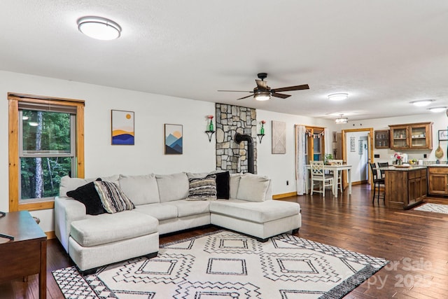 2171 Black Rock Rd, Cherokee, NC 28719 - living room featuring dark wood-style floors, ceiling fan, a textured ceiling, and a wood stove