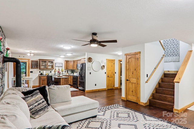2171 Black Rock Rd, Cherokee, NC 28719 - living room featuring dark wood finished floors, ceiling fan, stairway, and a textured ceiling