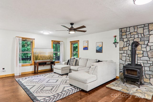2171 Black Rock Rd, Cherokee, NC 28719 - living room with wood-type flooring, a wood stove, plenty of natural light, ceiling fan, and a textured ceiling