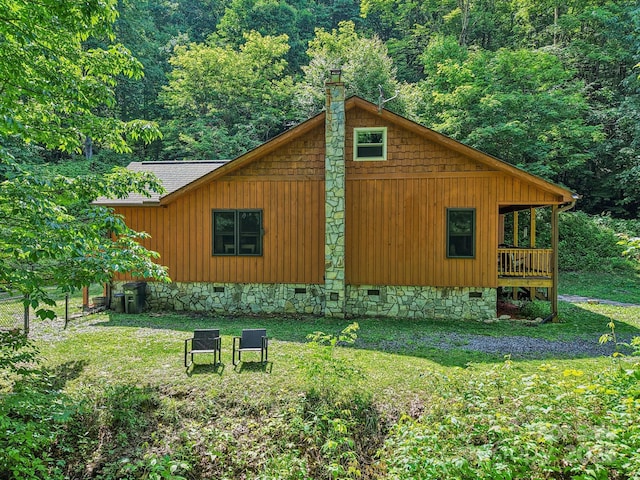 2171 Black Rock Rd, Cherokee, NC 28719 - view of property exterior featuring crawl space, a view of trees, a yard, and a chimney