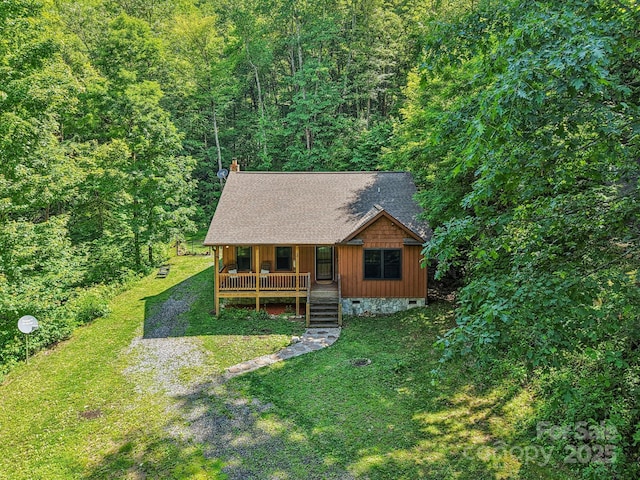 2171 Black Rock Rd, Cherokee, NC 28719 - chalet / cabin with covered porch, a front yard, crawl space, and a view of trees