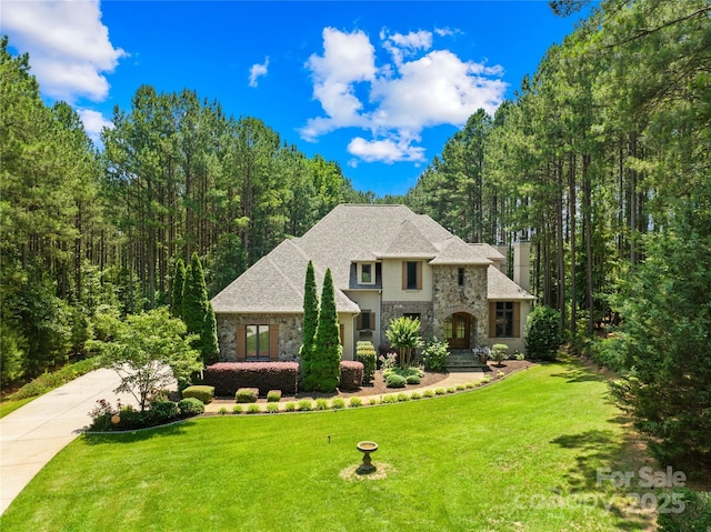 168 Blue Ridge Trl, Mooresville, NC 28117 - view of front of home with stone siding, a front lawn, concrete driveway, and stucco siding