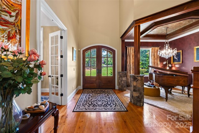 168 Blue Ridge Trl, Mooresville, NC 28117 - entryway featuring french doors, a chandelier, wood-type flooring, and arched walkways