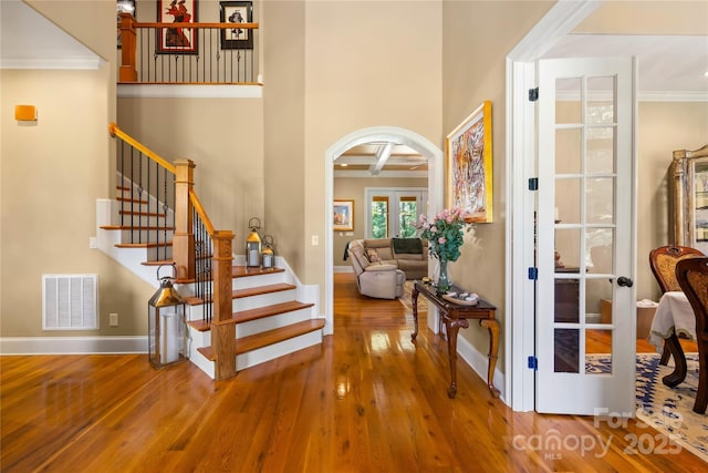 168 Blue Ridge Trl, Mooresville, NC 28117 - entryway with wood finished floors, arched walkways, stairway, crown molding, and a towering ceiling