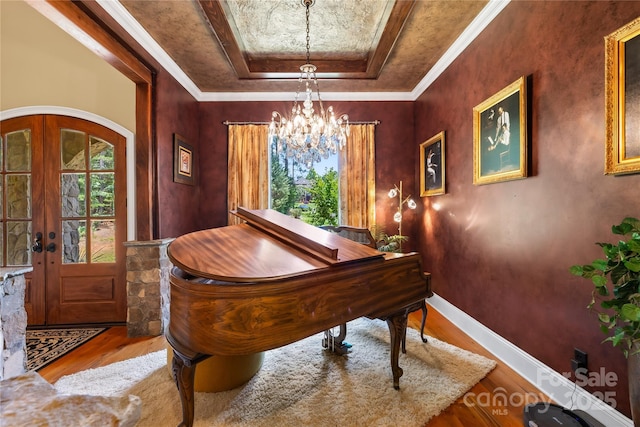 168 Blue Ridge Trl, Mooresville, NC 28117 - foyer with a tray ceiling, wood finished floors, a chandelier, and french doors