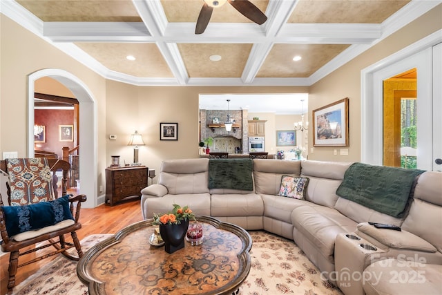 168 Blue Ridge Trl, Mooresville, NC 28117 - living area with arched walkways, coffered ceiling, light wood-style floors, ceiling fan, and beamed ceiling