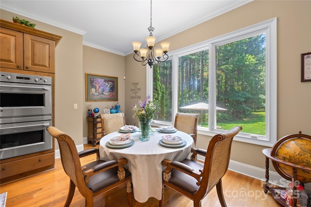 168 Blue Ridge Trl, Mooresville, NC 28117 - dining space with a chandelier, light wood-type flooring, healthy amount of natural light, and crown molding