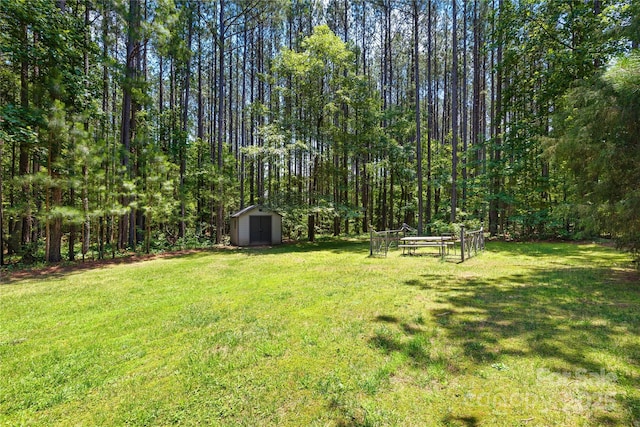 168 Blue Ridge Trl, Mooresville, NC 28117 - view of grassy yard with a storage shed and a wooded view
