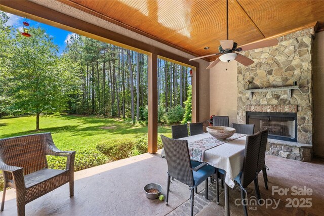 168 Blue Ridge Trl, Mooresville, NC 28117 - view of patio / terrace with an outdoor stone fireplace, ceiling fan, and outdoor dining area