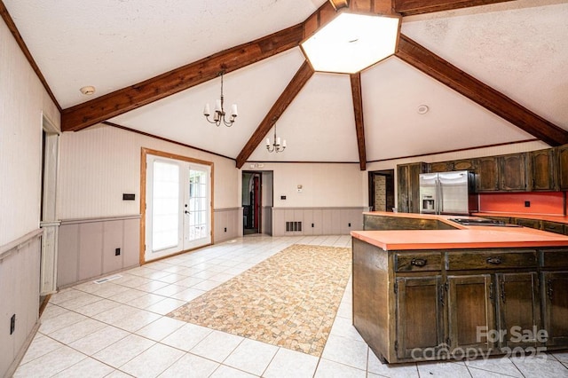 4275 Herman Sipe Rd, Conover, NC 28613 - kitchen with stainless steel fridge with ice dispenser, a chandelier, light tile patterned floors, open floor plan, and wainscoting