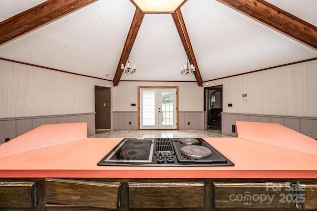 4275 Herman Sipe Rd, Conover, NC 28613 - kitchen featuring black electric cooktop, wainscoting, and a chandelier
