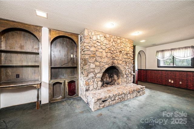 4275 Herman Sipe Rd, Conover, NC 28613 - unfurnished living room with a textured ceiling, carpet flooring, and a stone fireplace
