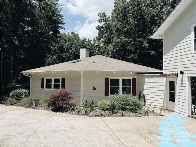 5017 Celeste Ct, Charlotte, NC 27609 - rear view of property with a chimney, a patio, and a shingled roof