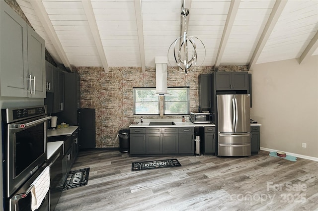 5017 Celeste Ct, Charlotte, NC 27609 - kitchen with stainless steel appliances, light countertops, light wood-type flooring, wood ceiling, and gray cabinets
