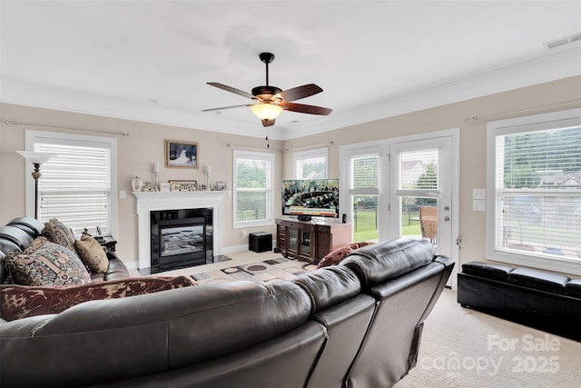 1636 Ridge Haven Rd, Waxhaw, NC 28173 - living area featuring ornamental molding, a fireplace with flush hearth, healthy amount of natural light, ceiling fan, and light colored carpet