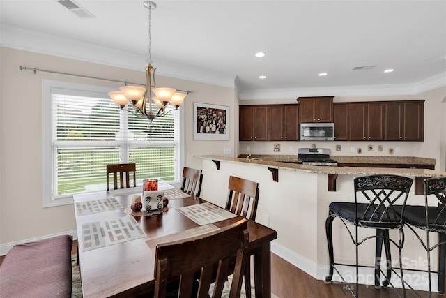 1636 Ridge Haven Rd, Waxhaw, NC 28173 - dining room featuring a chandelier, crown molding, dark wood-style floors, and recessed lighting