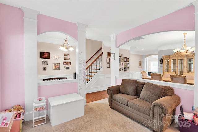 1636 Ridge Haven Rd, Waxhaw, NC 28173 - carpeted living area with a chandelier, arched walkways, crown molding, a wainscoted wall, and recessed lighting