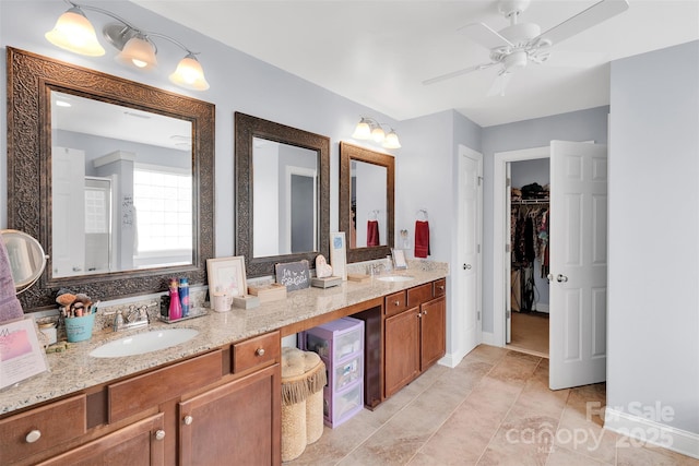 1636 Ridge Haven Rd, Waxhaw, NC 28173 - bathroom featuring double vanity, a ceiling fan, a spacious closet, tile patterned flooring, and a shower