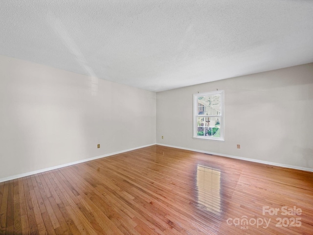 2020 Dawnshire Dr, Gastonia, NC 28054 - empty room with hardwood / wood-style flooring and a textured ceiling