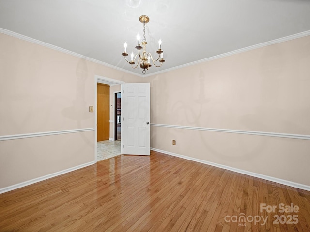 2020 Dawnshire Dr, Gastonia, NC 28054 - spare room featuring a chandelier, wood finished floors, and ornamental molding