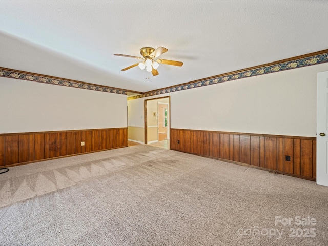 2020 Dawnshire Dr, Gastonia, NC 28054 - carpeted empty room featuring ceiling fan, a wainscoted wall, and wood walls