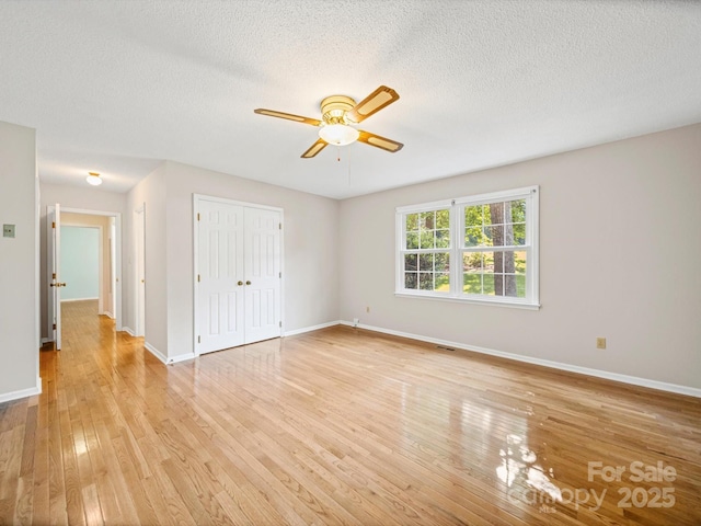 2020 Dawnshire Dr, Gastonia, NC 28054 - unfurnished bedroom featuring light wood-style flooring, a textured ceiling, a closet, and a ceiling fan
