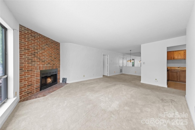1604 Sharon Rd W Unit 30, Charlotte, NC 28210 - unfurnished living room featuring a fireplace and light colored carpet