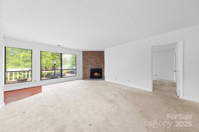 1604 Sharon Rd W Unit 30, Charlotte, NC 28210 - unfurnished living room featuring carpet floors, a brick fireplace, and a textured ceiling