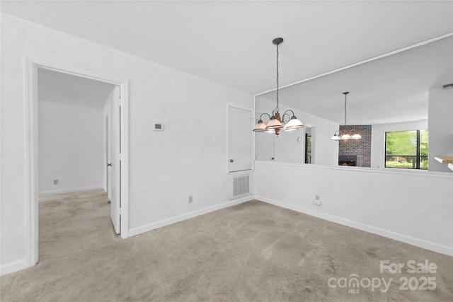 1604 Sharon Rd W Unit 30, Charlotte, NC 28210 - carpeted empty room featuring a chandelier and baseboards