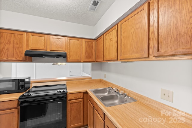 1604 Sharon Rd W Unit 30, Charlotte, NC 28210 - kitchen with black appliances, light countertops, under cabinet range hood, a textured ceiling, and brown cabinetry