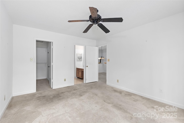 1604 Sharon Rd W Unit 30, Charlotte, NC 28210 - unfurnished bedroom with a walk in closet, a closet, light colored carpet, connected bathroom, and ceiling fan