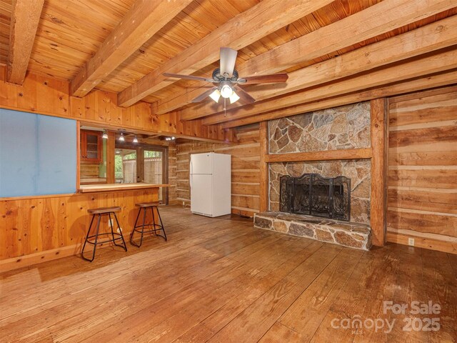 5109 Walnut Grove Ln, Charlotte, NC 28227 - unfurnished living room with wood walls, hardwood / wood-style floors, a wood ceiling with exposed beams, a fireplace, and a ceiling fan
