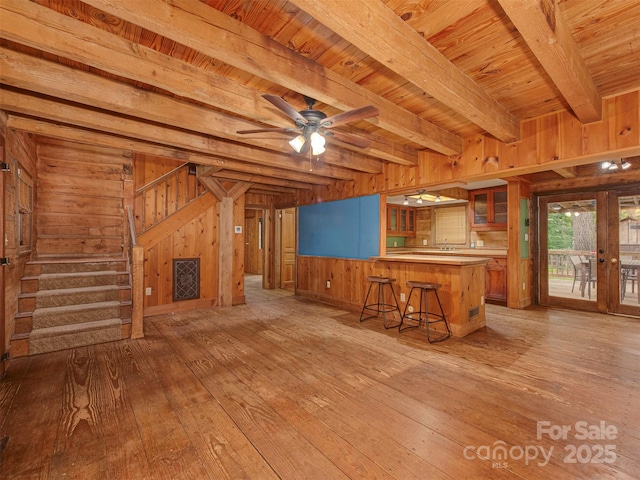 5109 Walnut Grove Ln, Charlotte, NC 28227 - kitchen with wooden walls, light wood-style floors, a breakfast bar area, a wooden ceiling with exposed beams, and french doors