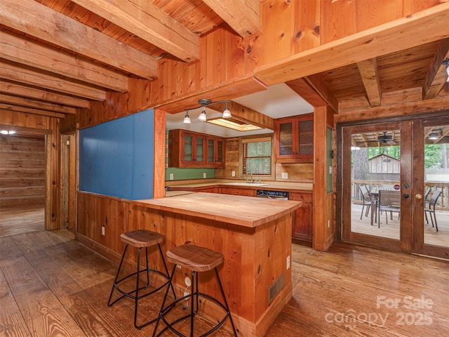 5109 Walnut Grove Ln, Charlotte, NC 28227 - kitchen featuring wooden counters, wood walls, hardwood / wood-style flooring, a wood ceiling with exposed beams, and a kitchen breakfast bar