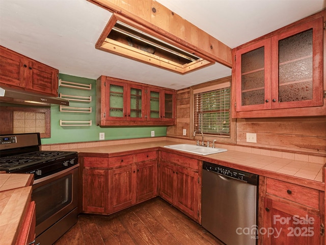 5109 Walnut Grove Ln, Charlotte, NC 28227 - kitchen featuring stainless steel appliances, under cabinet range hood, dark wood finished floors, and tile counters