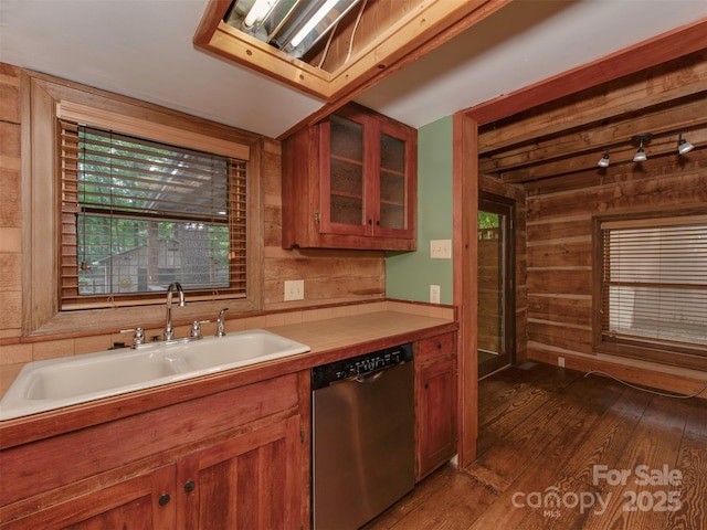 5109 Walnut Grove Ln, Charlotte, NC 28227 - kitchen with stainless steel dishwasher, wood walls, dark wood-style flooring, glass insert cabinets, and brown cabinetry