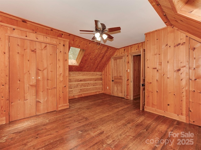 5109 Walnut Grove Ln, Charlotte, NC 28227 - bonus room with wood walls, wood-type flooring, ceiling fan, vaulted ceiling, and a skylight