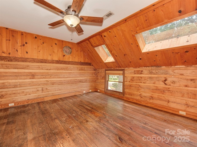 5109 Walnut Grove Ln, Charlotte, NC 28227 - additional living space featuring a skylight, wooden walls, hardwood / wood-style floors, ceiling fan, and vaulted ceiling