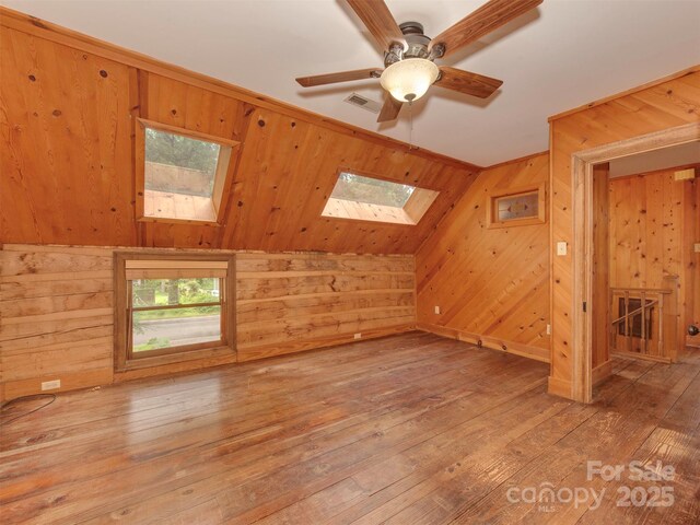 5109 Walnut Grove Ln, Charlotte, NC 28227 - additional living space with a skylight, light wood finished floors, wooden walls, and a ceiling fan