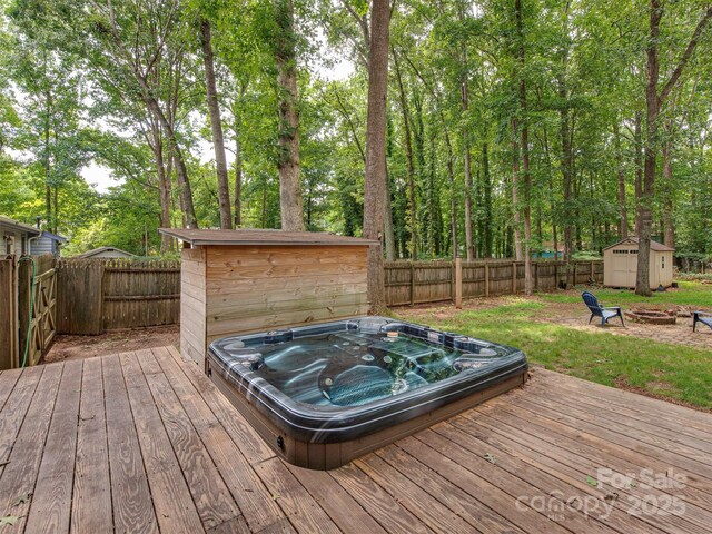 5109 Walnut Grove Ln, Charlotte, NC 28227 - wooden terrace featuring a storage unit, an outdoor fire pit, a fenced backyard, and view of scattered trees