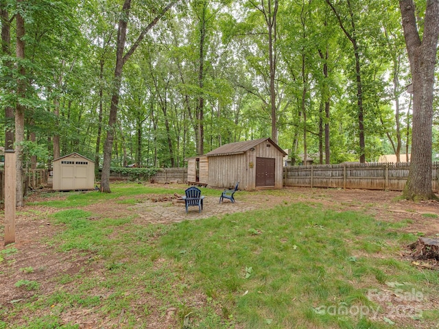 5109 Walnut Grove Ln, Charlotte, NC 28227 - fenced backyard with a storage shed, a garage, and an outdoor fire pit