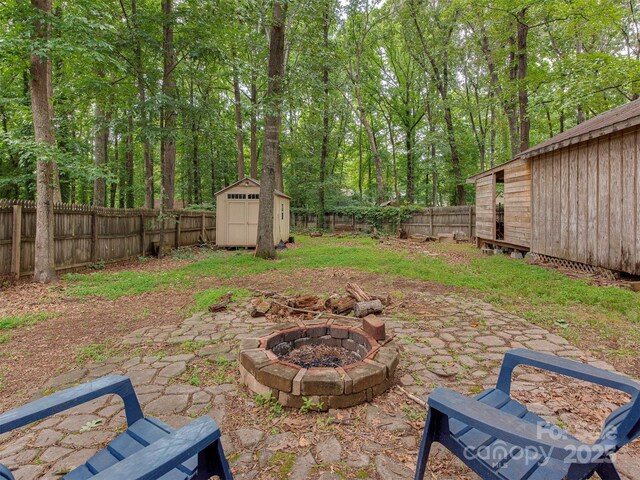 5109 Walnut Grove Ln, Charlotte, NC 28227 - fenced backyard with a fire pit, a storage unit, and a patio