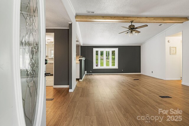 311 Flynn Br, Madison, NC 28753 - unfurnished living room featuring ceiling fan, a textured ceiling, wood finished floors, and ornamental molding