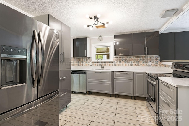 311 Flynn Br, Madison, NC 28753 - kitchen with stainless steel appliances, gray cabinets, a textured ceiling, tasteful backsplash, and light countertops