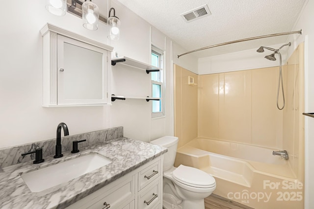 311 Flynn Br, Madison, NC 28753 - full bathroom with a textured ceiling, vanity, bathing tub / shower combination, and wood finished floors